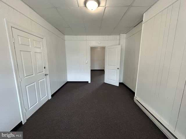 919 S Queen St, York, PA 17403 - interior space with a baseboard heating unit, dark colored carpet, and a drop ceiling