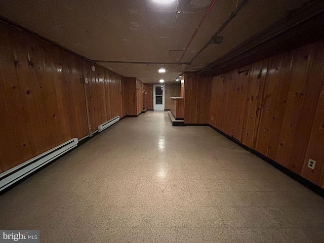 919 S Queen St, York, PA 17403 - finished below grade area featuring a baseboard radiator, wooden walls, baseboards, and light floors