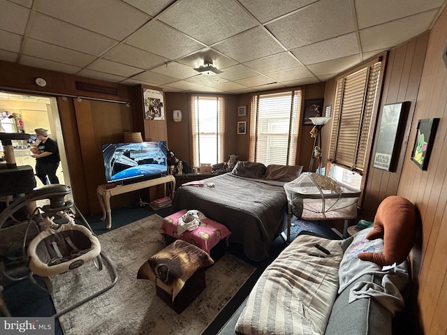 919 S Queen St, York, PA 17403 - carpeted bedroom with wooden walls and a paneled ceiling