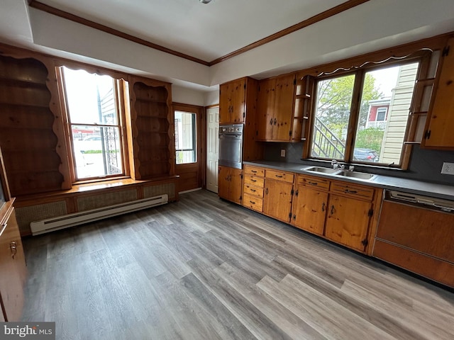 919 S Queen St, York, PA 17403 - kitchen with wall oven, baseboard heating, dishwasher, a sink, and light wood finished floors