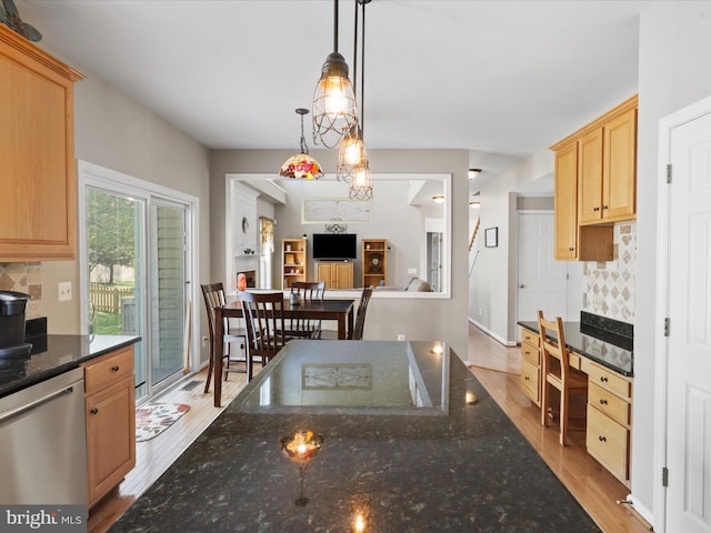 kitchen featuring decorative backsplash, light wood-style floors, and dishwasher