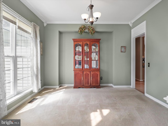 unfurnished dining area with crown molding, a healthy amount of sunlight, carpet flooring, and visible vents