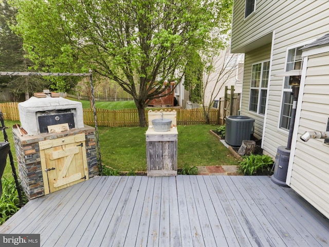 wooden deck featuring a yard, fence, and central AC unit