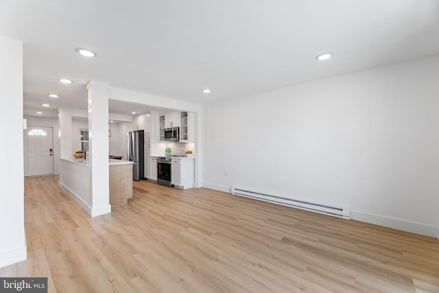 615 Salt Spray Rd Unit 3E, Ocean City, MD 21842 - unfurnished living room with recessed lighting, ornate columns, light wood-style floors, and a baseboard heating unit