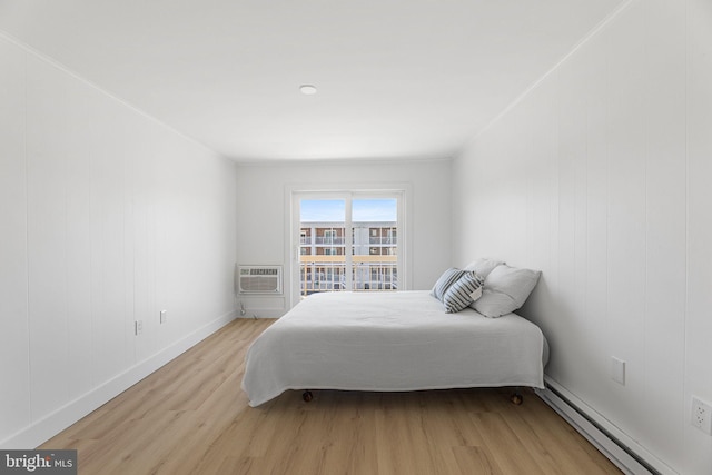 615 Salt Spray Rd Unit 3E, Ocean City, MD 21842 - bedroom featuring a wall mounted air conditioner, light wood finished floors, baseboard heating, and baseboards