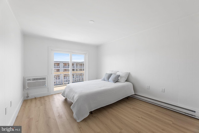 615 Salt Spray Rd Unit 3E, Ocean City, MD 21842 - bedroom featuring baseboards, an AC wall unit, a baseboard radiator, light wood-type flooring, and crown molding