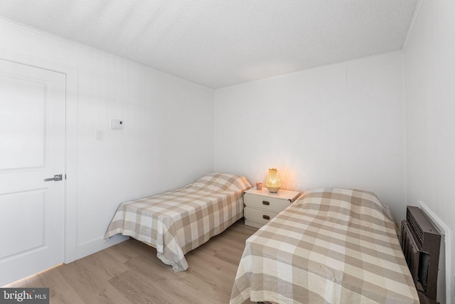 615 Salt Spray Rd Unit 3E, Ocean City, MD 21842 - bedroom featuring a textured ceiling and light wood finished floors