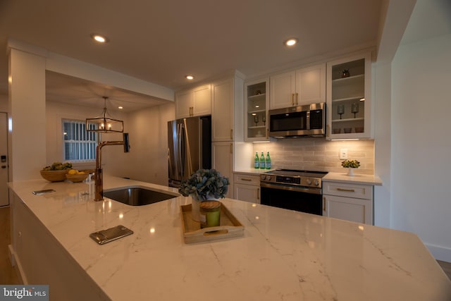 615 Salt Spray Rd Unit 3E, Ocean City, MD 21842 - kitchen with recessed lighting, white cabinetry, backsplash, stainless steel appliances, and a sink