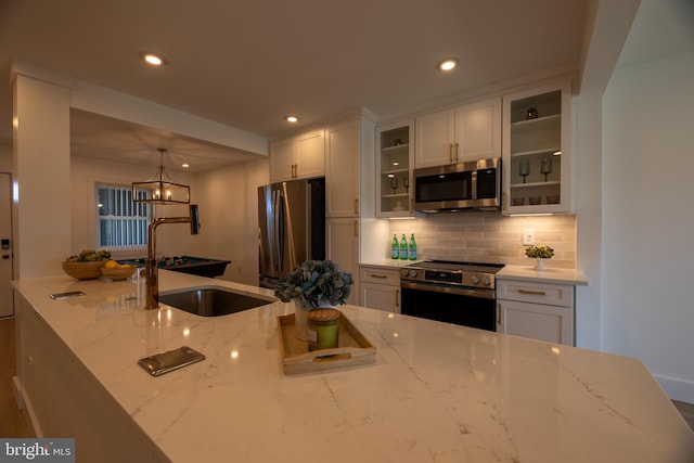 615 Salt Spray Rd Unit 3E, Ocean City, MD 21842 - kitchen featuring white cabinetry, recessed lighting, appliances with stainless steel finishes, a sink, and backsplash