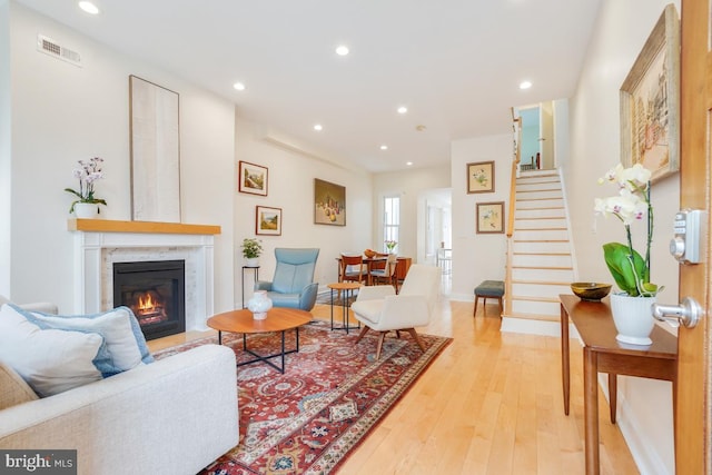 1809 12th St NW, Washington, DC 20009 - living room featuring light wood-style flooring, a glass covered fireplace, stairs, and recessed lighting