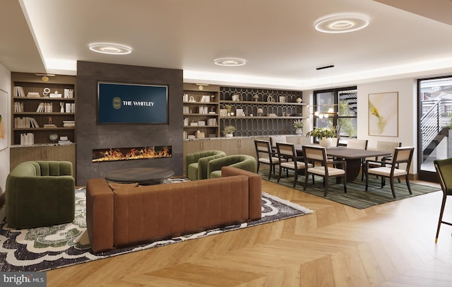 living room with built in features and a large fireplace