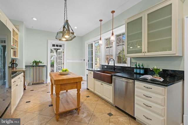 kitchen with pendant lighting, stainless steel dishwasher, radiator heating unit, light tile patterned flooring, and a sink