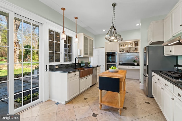 kitchen with open shelves, a sink, recessed lighting, stainless steel appliances, and light tile patterned flooring