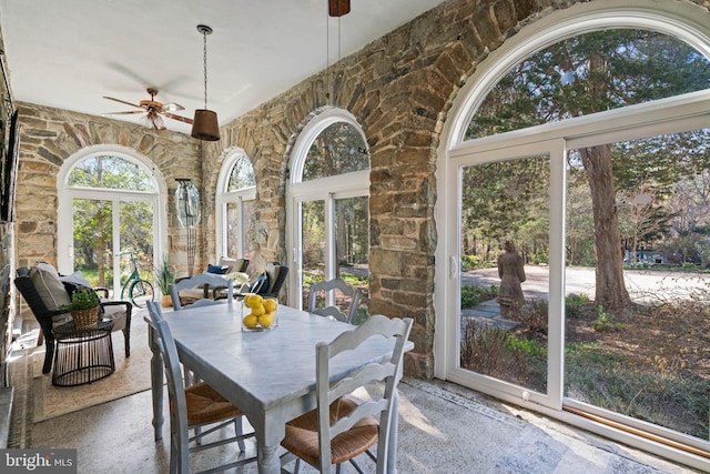 sunroom with a high ceiling and speckled floor