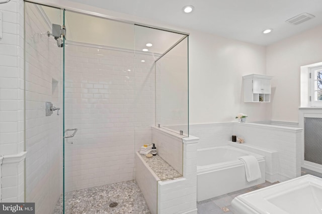 full bathroom with visible vents, recessed lighting, a wainscoted wall, a stall shower, and a garden tub