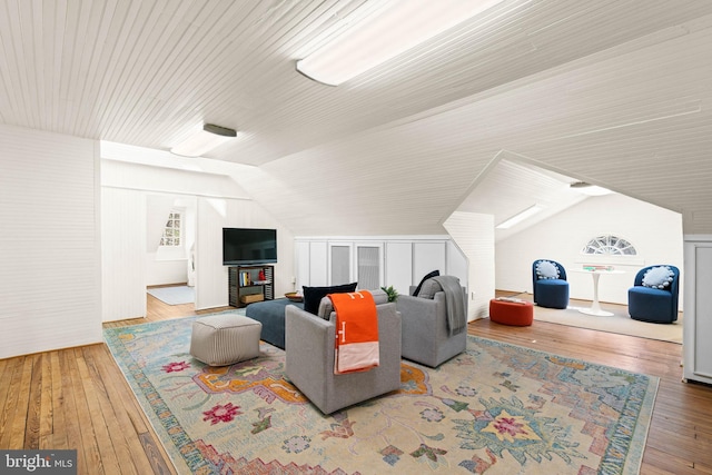 living area with lofted ceiling and hardwood / wood-style flooring