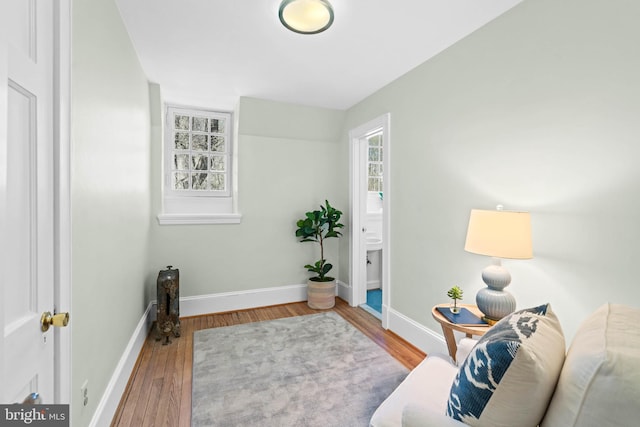 living area featuring baseboards and wood finished floors