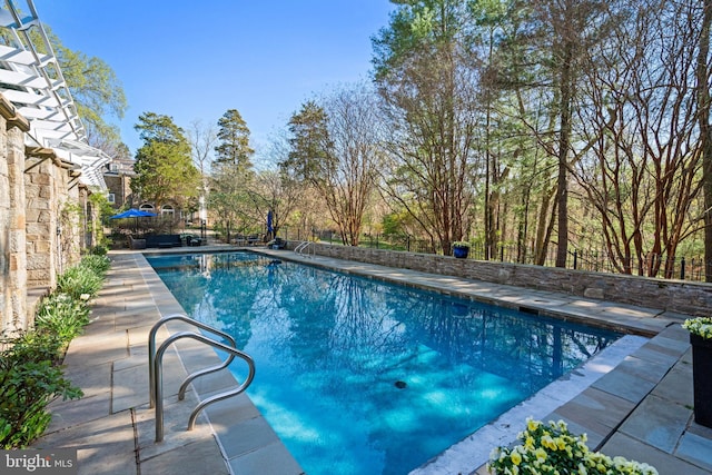 view of pool with a patio area, fence, and a fenced in pool