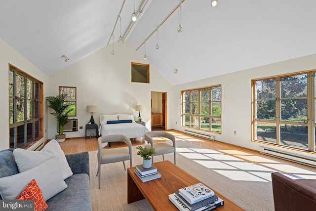 living room with plenty of natural light, a baseboard heating unit, and light wood-style floors