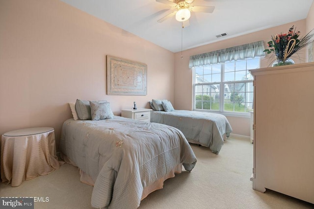 bedroom featuring visible vents, light colored carpet, and a ceiling fan