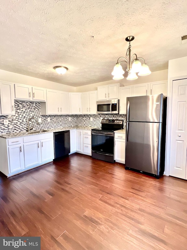 kitchen featuring a sink, white cabinets, appliances with stainless steel finishes, and a textured ceiling