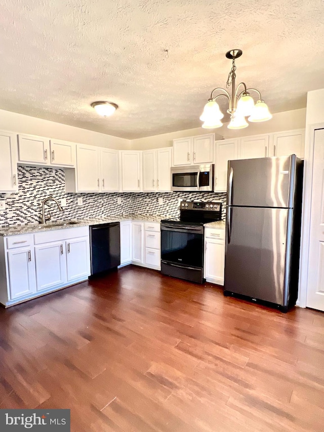 kitchen with a sink, white cabinetry, and stainless steel appliances