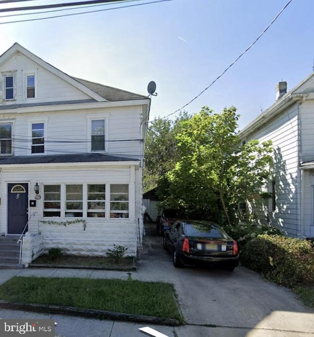 view of front of property featuring entry steps and concrete driveway