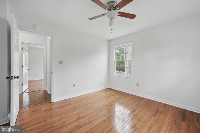 unfurnished bedroom featuring light wood-style floors, baseboards, and a ceiling fan