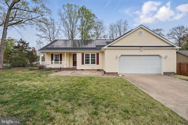 single story home with a front yard, roof mounted solar panels, an attached garage, covered porch, and concrete driveway