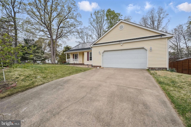 view of front of property featuring a front yard, a porch, an attached garage, and driveway