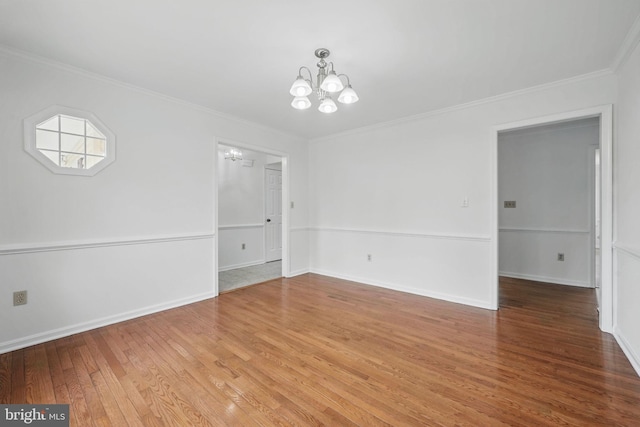 unfurnished dining area with light wood-style floors, baseboards, an inviting chandelier, and ornamental molding