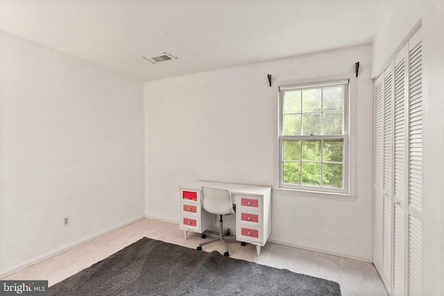 carpeted office featuring baseboards