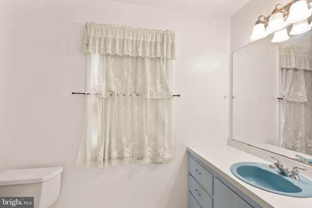 bathroom featuring toilet and vanity