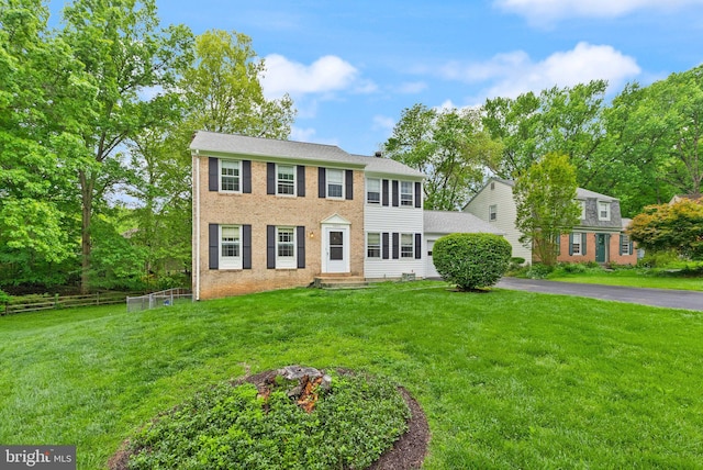 colonial home featuring brick siding