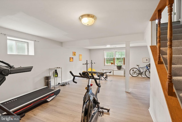 workout room with light wood finished floors and baseboards