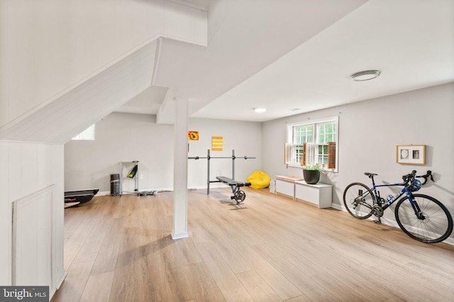 workout area with wood finished floors and baseboards