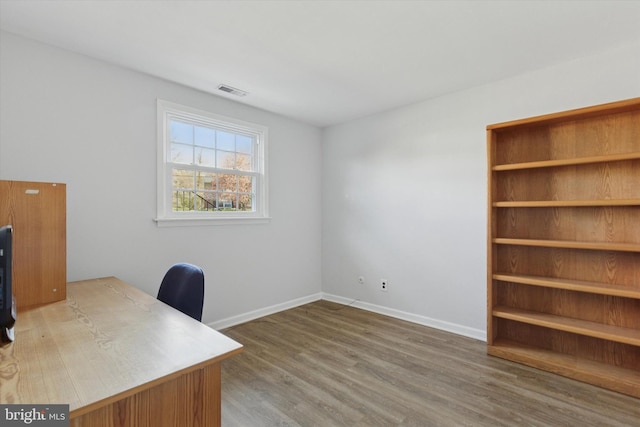 home office with wood finished floors, baseboards, and visible vents