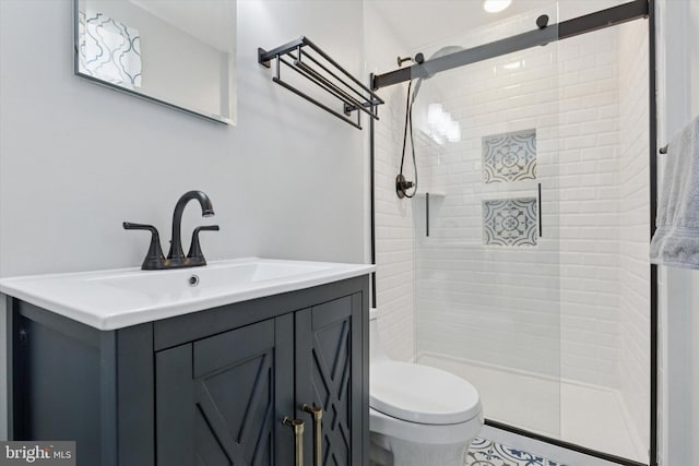 bathroom featuring vanity, a stall shower, and toilet