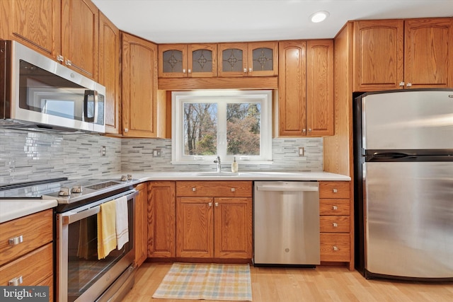kitchen with a sink, light countertops, and stainless steel appliances
