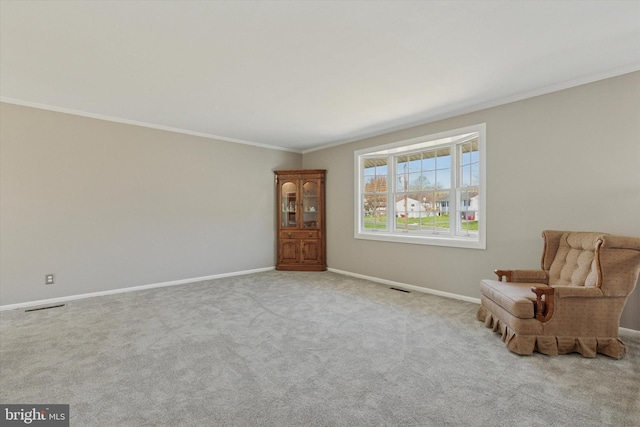 unfurnished room with ornamental molding, baseboards, and visible vents