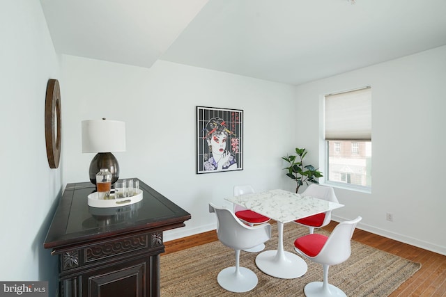 dining area featuring baseboards and wood finished floors