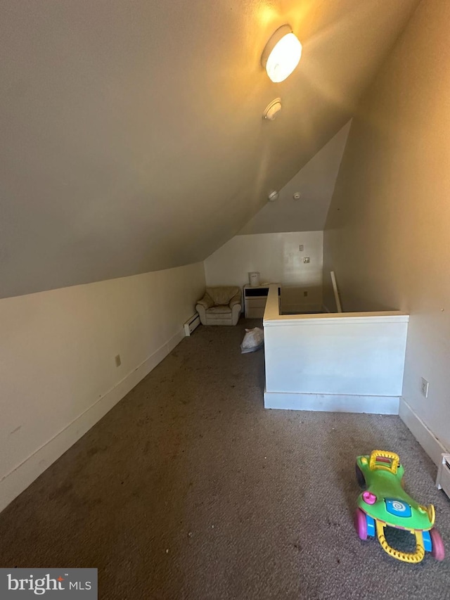 additional living space featuring baseboards, carpet flooring, a baseboard heating unit, and vaulted ceiling