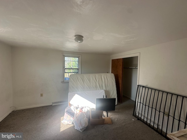 bedroom with a baseboard radiator, a closet, and baseboards