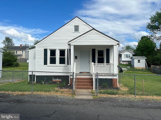 bungalow-style home featuring covered porch and a gate
