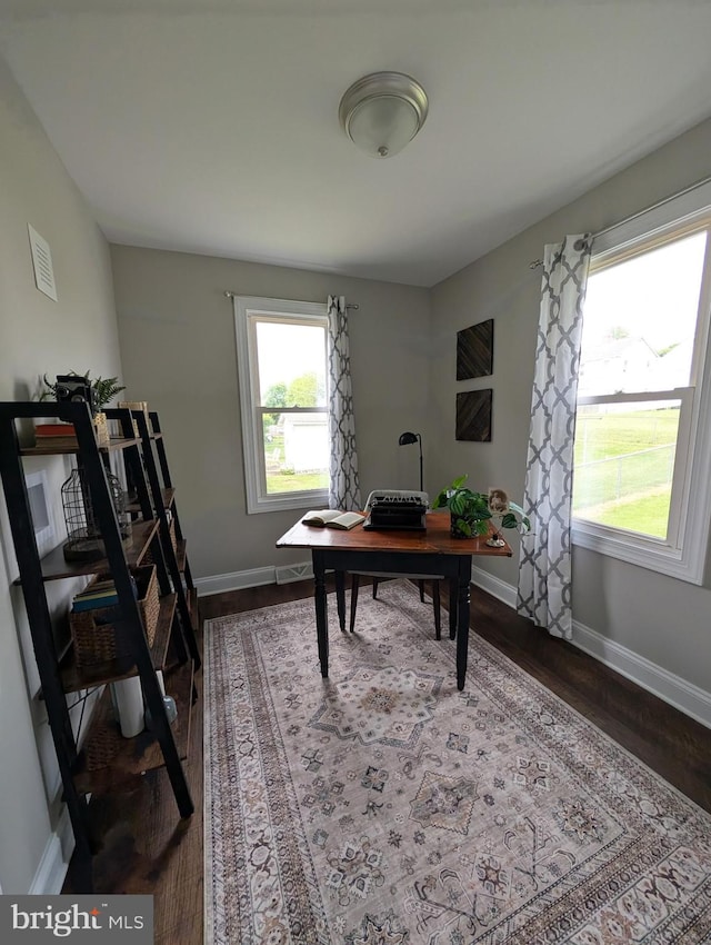 home office with baseboards and dark wood-style floors