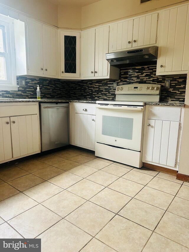 5001 Franklin St, Harrisburg, PA 17111 - kitchen with light tile patterned floors, white electric stove, under cabinet range hood, decorative backsplash, and stainless steel dishwasher