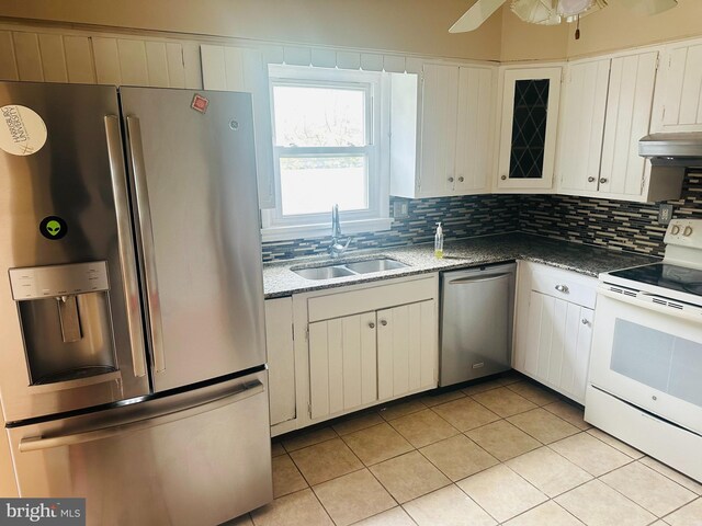 5001 Franklin St, Harrisburg, PA 17111 - kitchen featuring a sink, appliances with stainless steel finishes, under cabinet range hood, backsplash, and light tile patterned flooring
