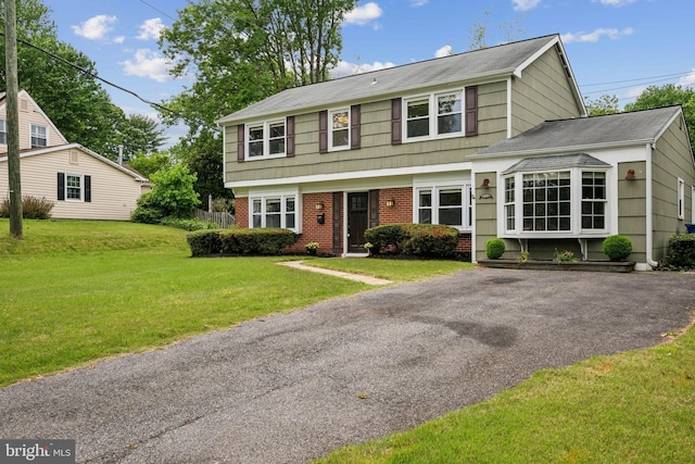 12430 Shadow Ln, Bowie, MD 20715 - colonial inspired home with brick siding, a front lawn, and roof with shingles