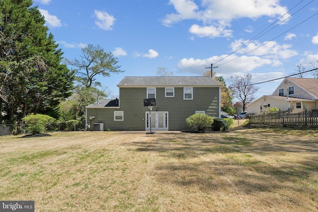 rear view of house featuring central air condition unit, a yard, french doors, and fence