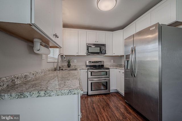 kitchen featuring stainless steel appliances, dark wood-style floors, white cabinetry, and a sink